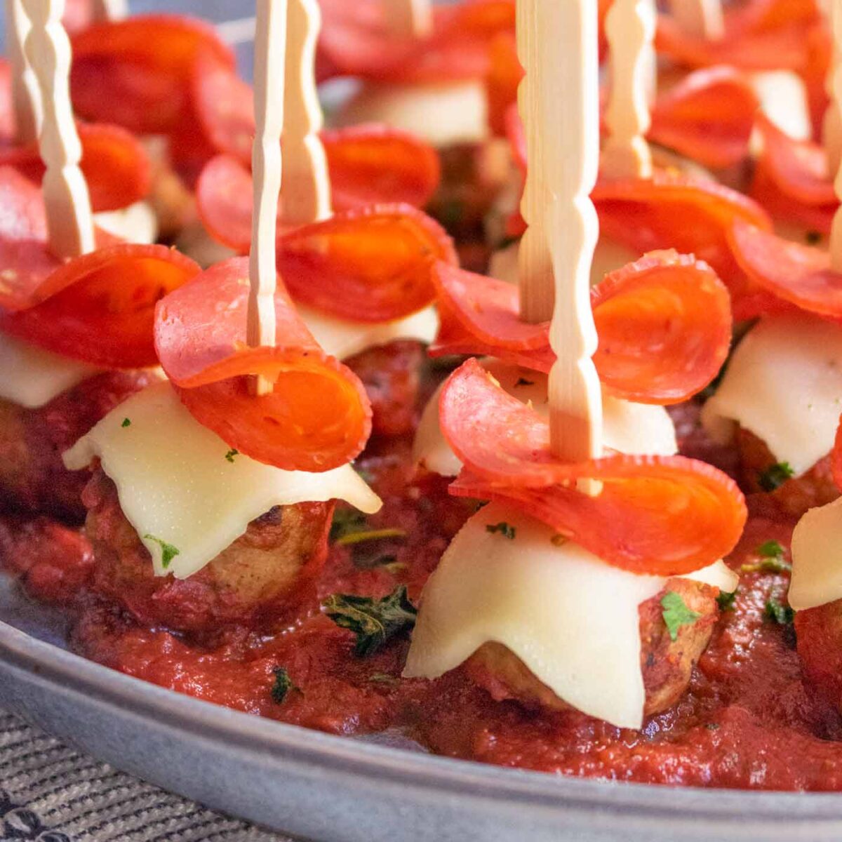 Close-up of Pizza Meatballs on a gray plate.
