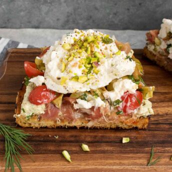 Side view of a Mediterranean Burrata Fried Toast, sliced in half.