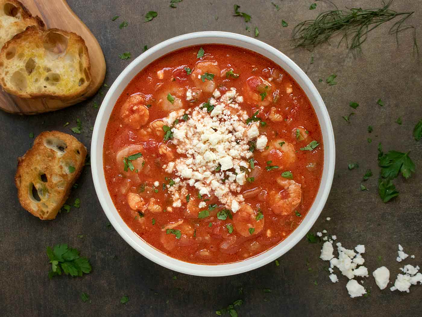 Shrimp Saganaki Soup in a white bowl.