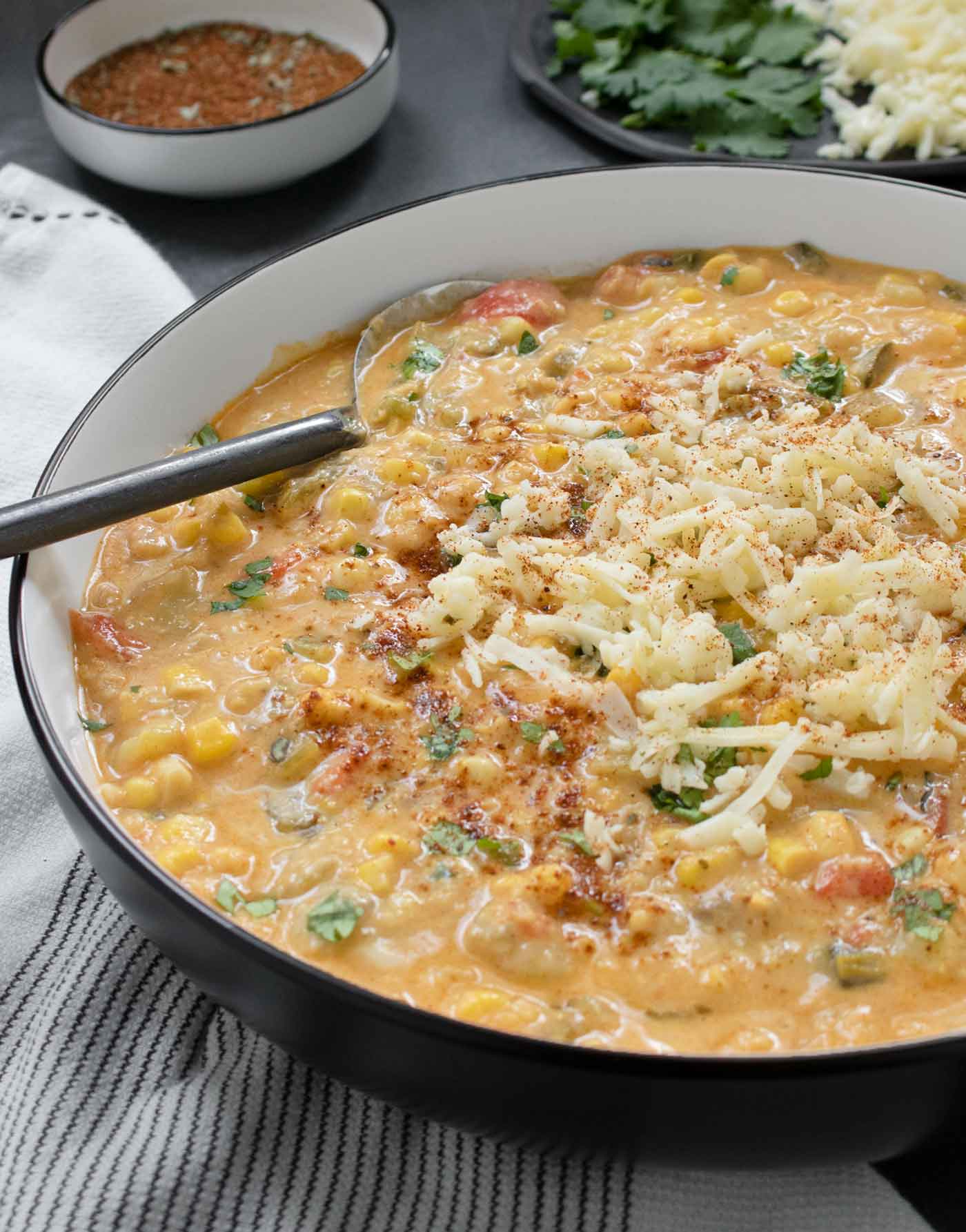 Side-angled view of a bowl of the soup, with a spoon.