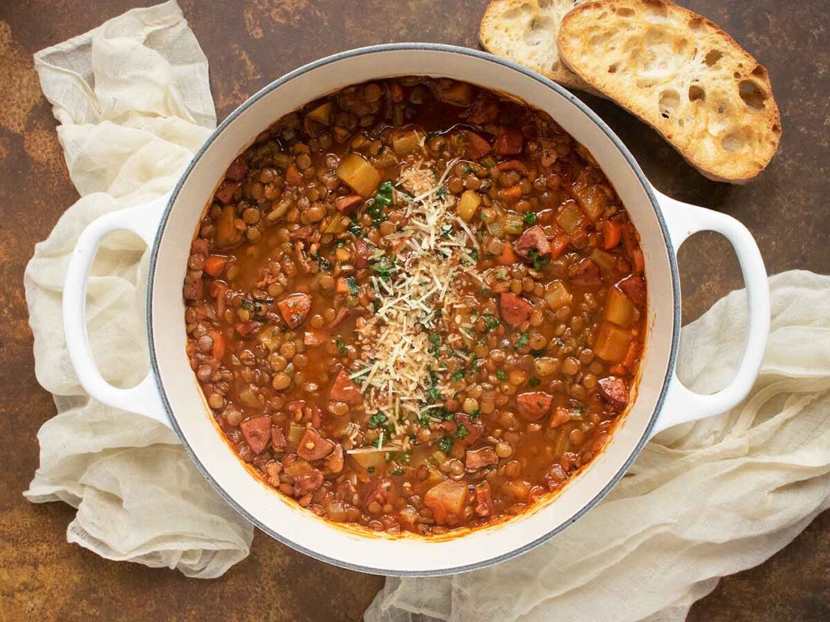 Rustic Lentil Soup in a large white Dutch oven.