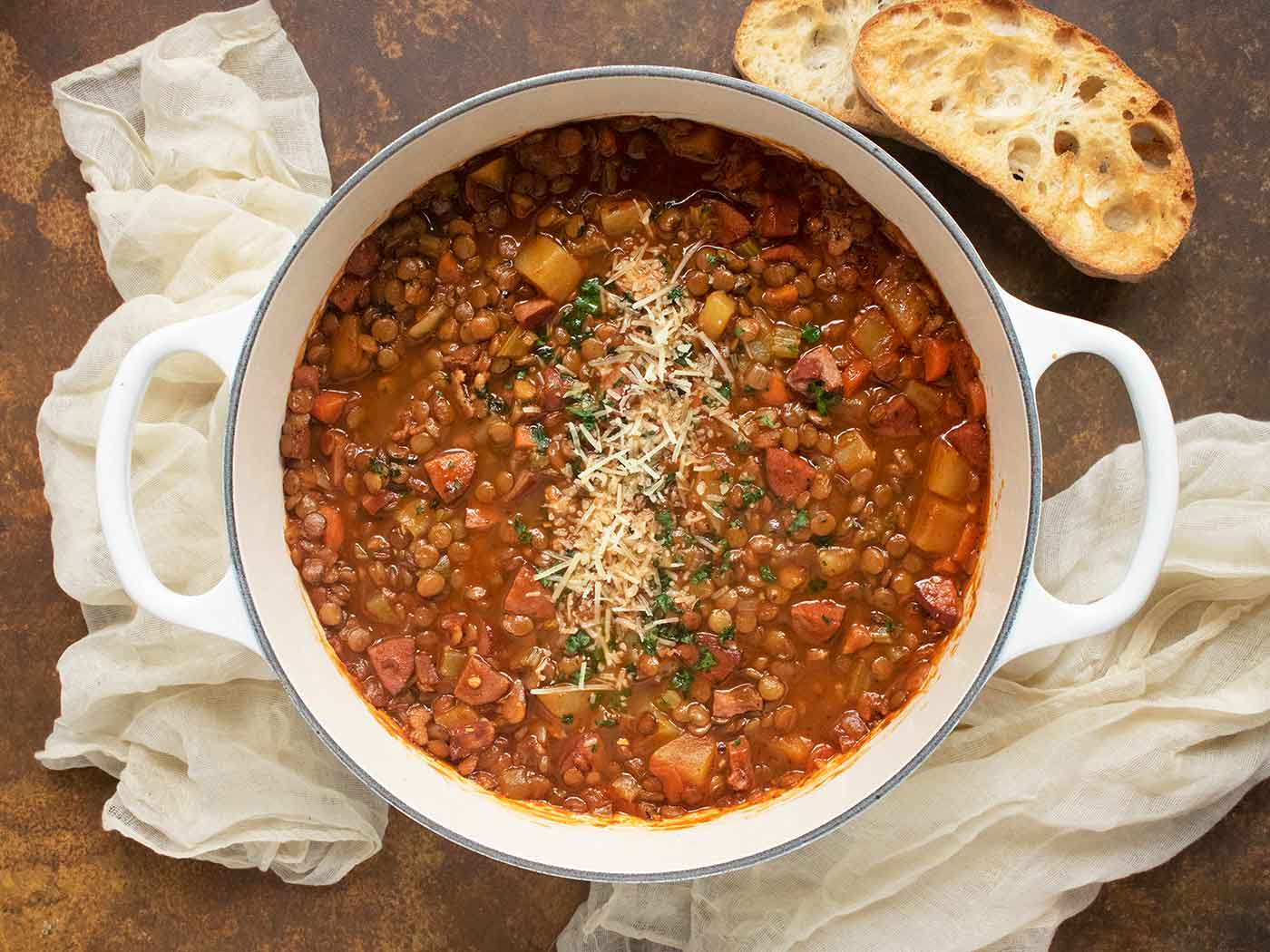 Rustic Lentil Soup in a large white Dutch oven.