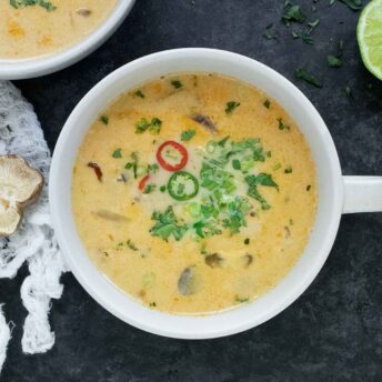 Overhead view of Thai Coconut Mushroom Soup in a white bowl.