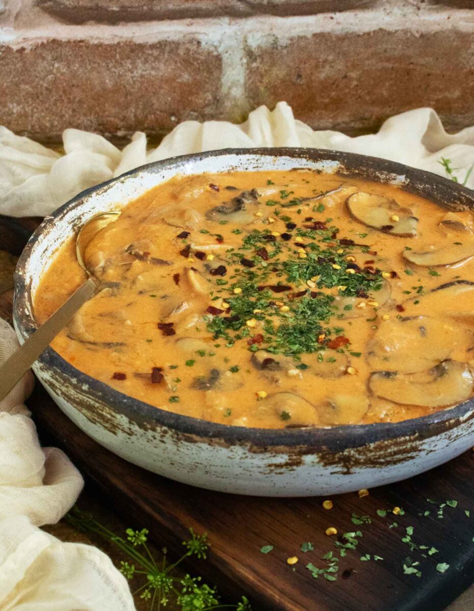 Side-angled view of a bowl of Thai Coconut Mushroom Soup.