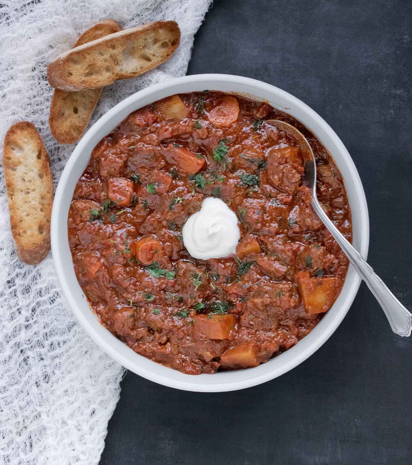 Overhead view of Austrian Hungarian Goulash with a spoon.