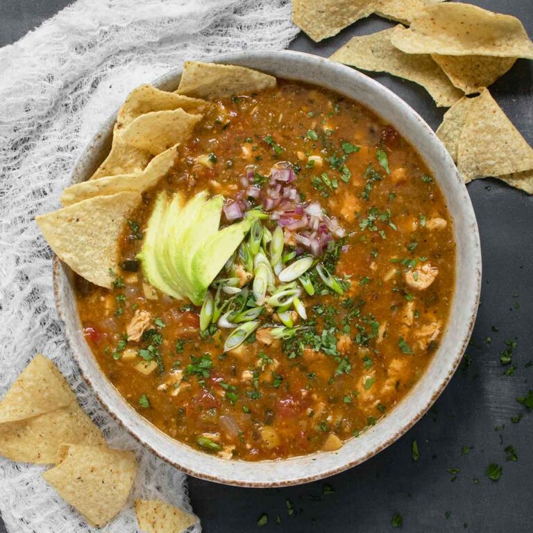 An overhead view of a bowl of Chile Verde Tortilla Soup.