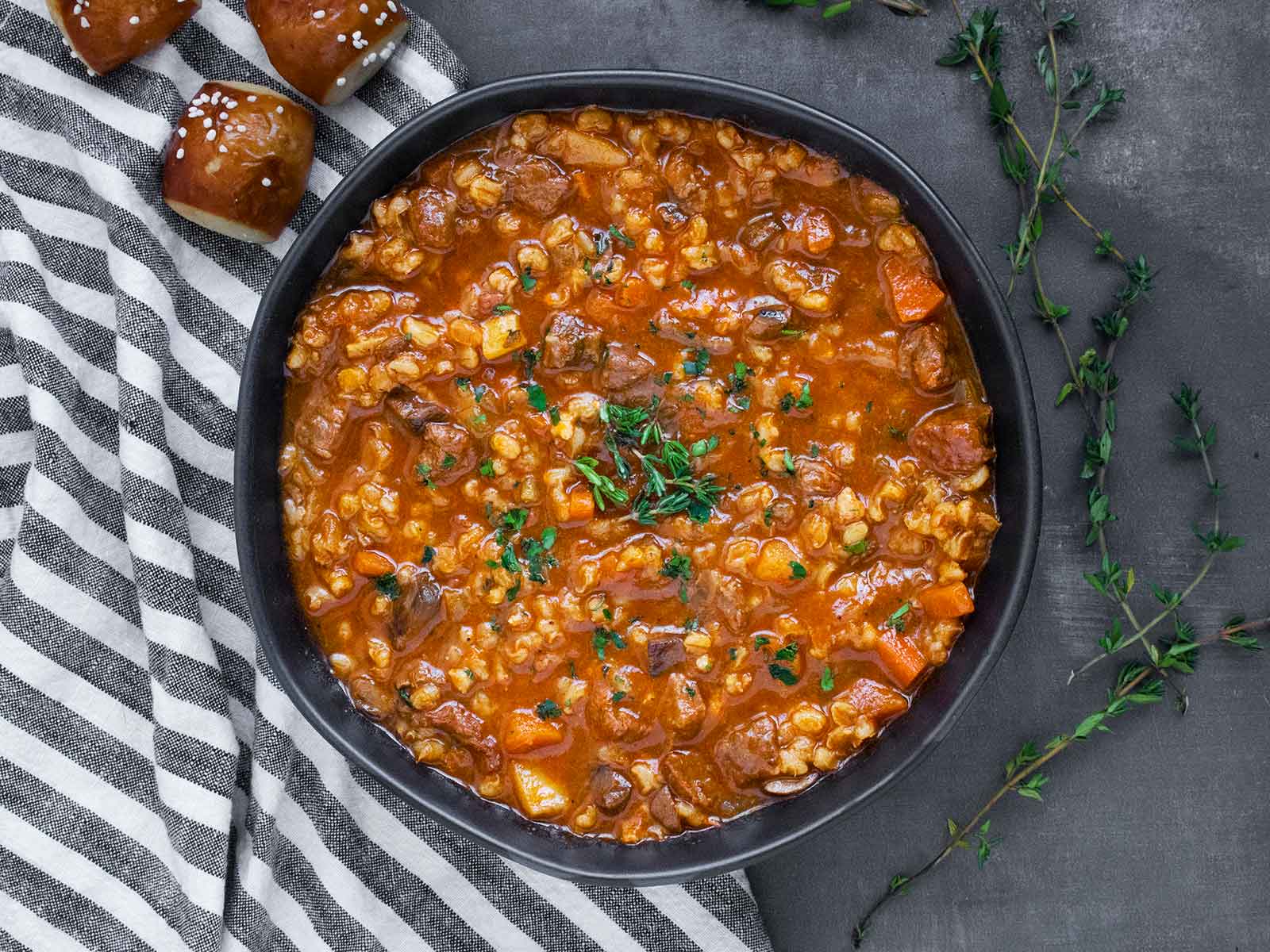 Overhead view of a bowl of Beef Barley Soup.