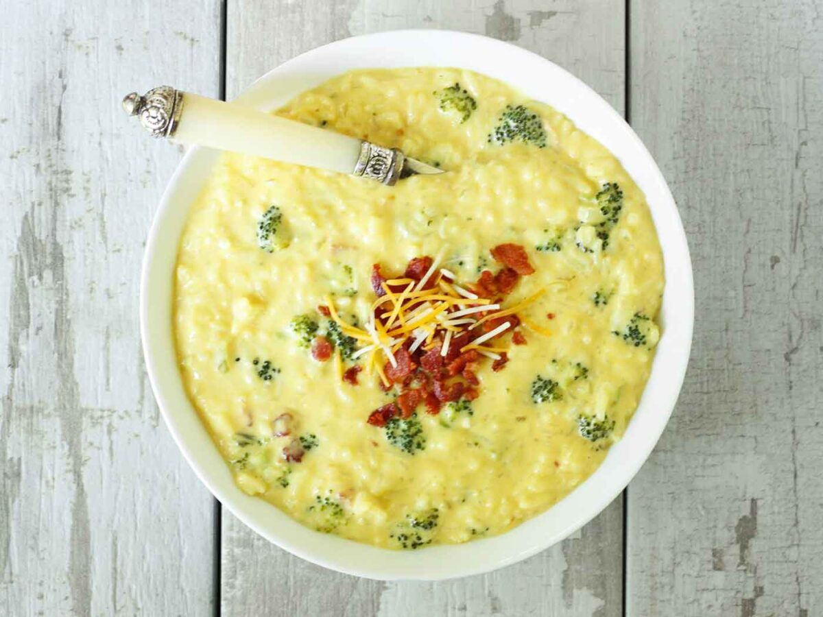 Overhead view of a bowl of Cheesy Broccoli Rice & Bacon Soup.