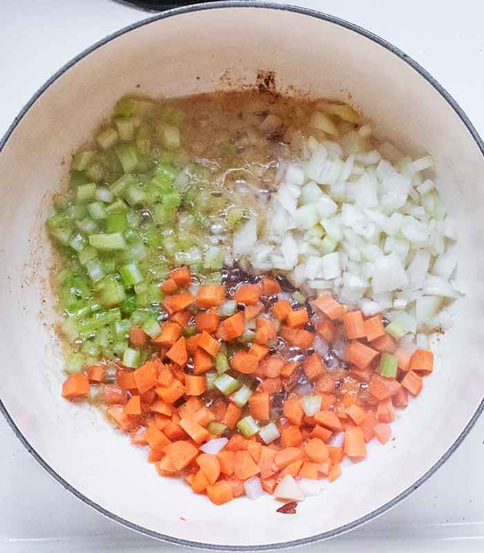 Onions, carrots, and celery cooking in the bacon fat.