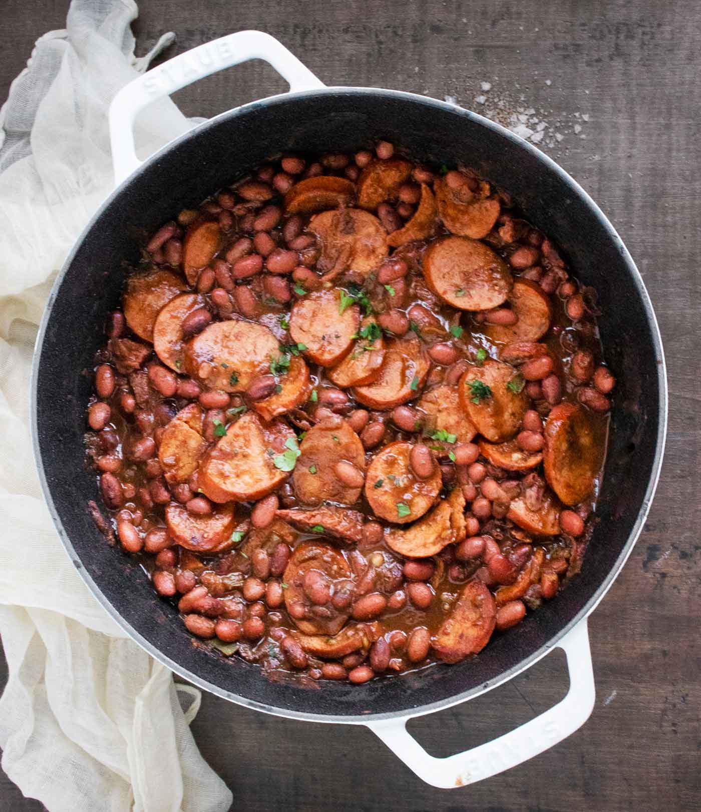 An overhead view of red beans and sausage in the pot, ready to serve.