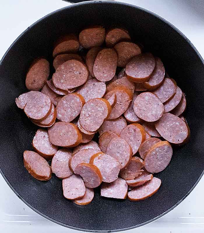 Andouille sausage slices in the soup pot.