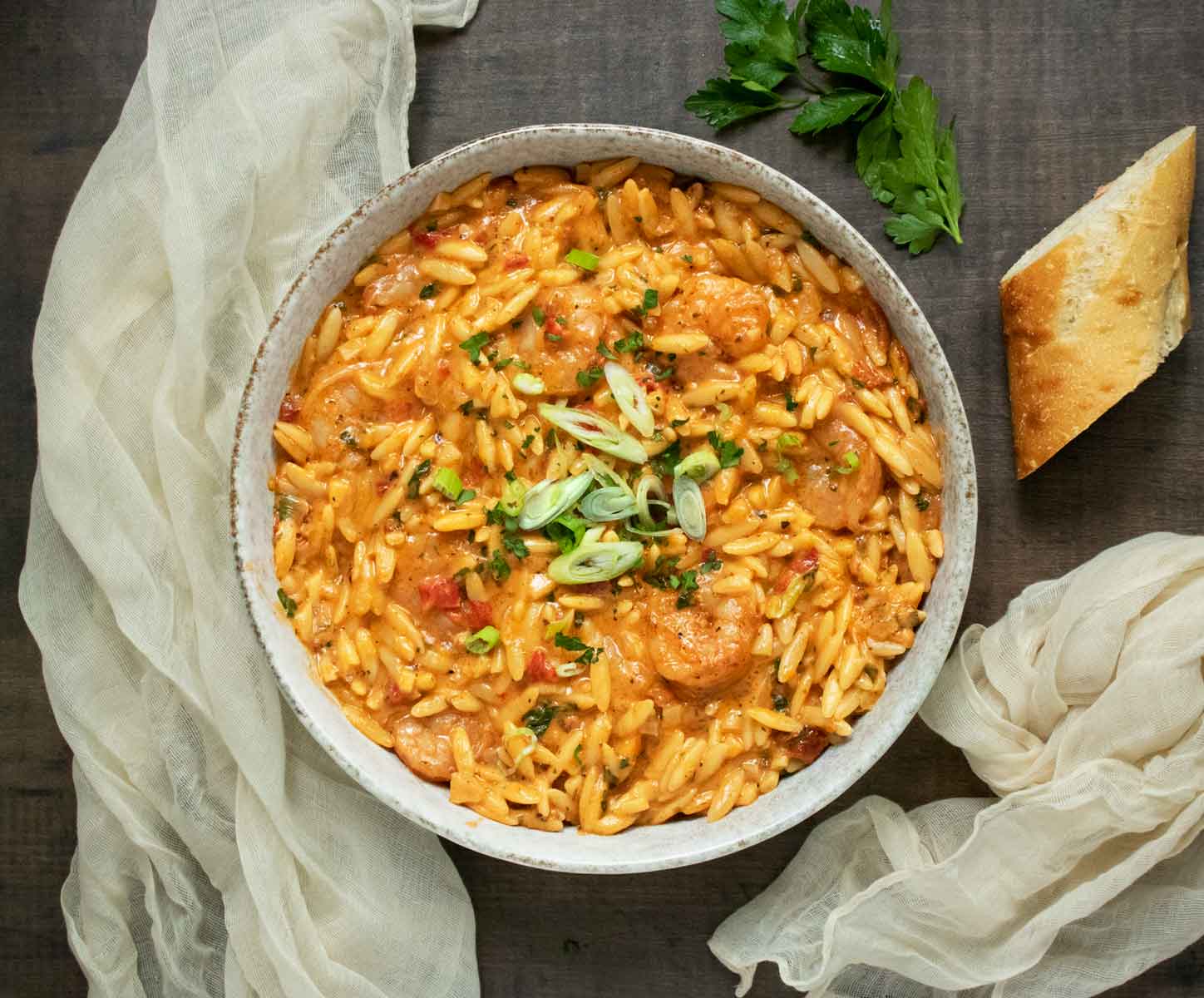 Marry Me Shrimp & Orzo in a bowl with a side of bread.