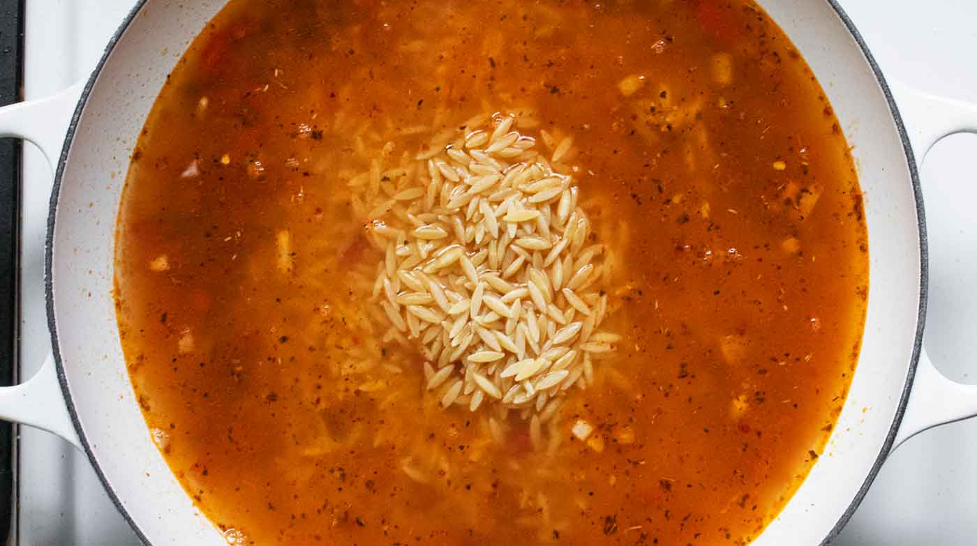 Adding the liquids and orzo.