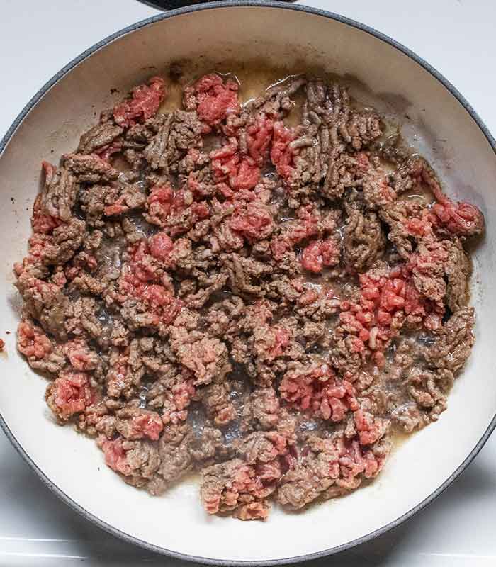 Ground beef cooking in the skillet.
