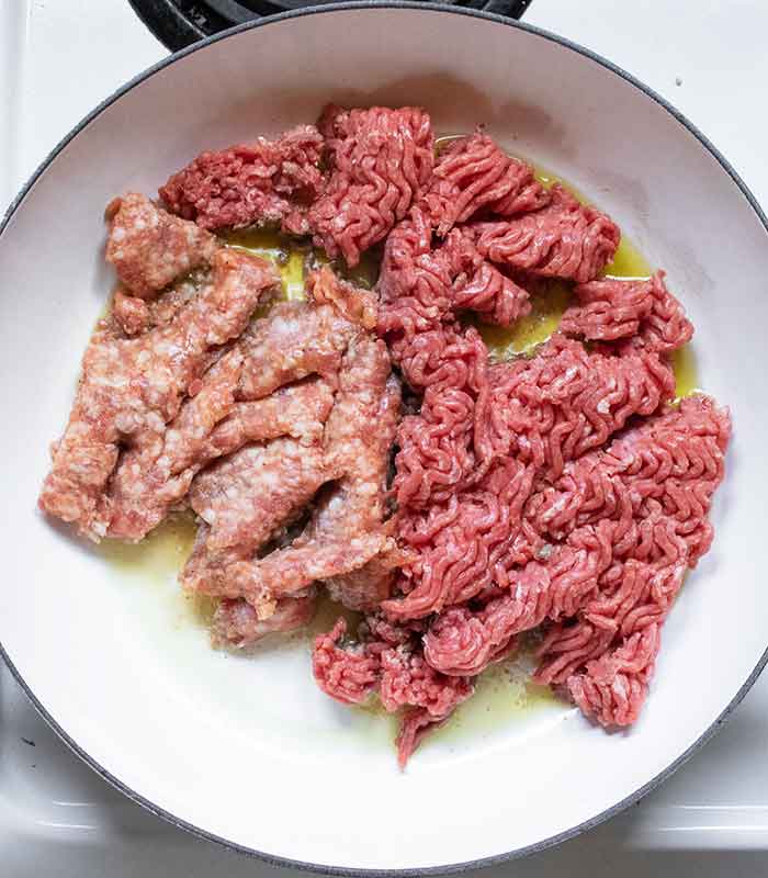 Lean ground beef and Italian sausage start the cook.