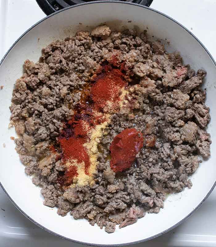 Tomato paste and spices go in the pot.