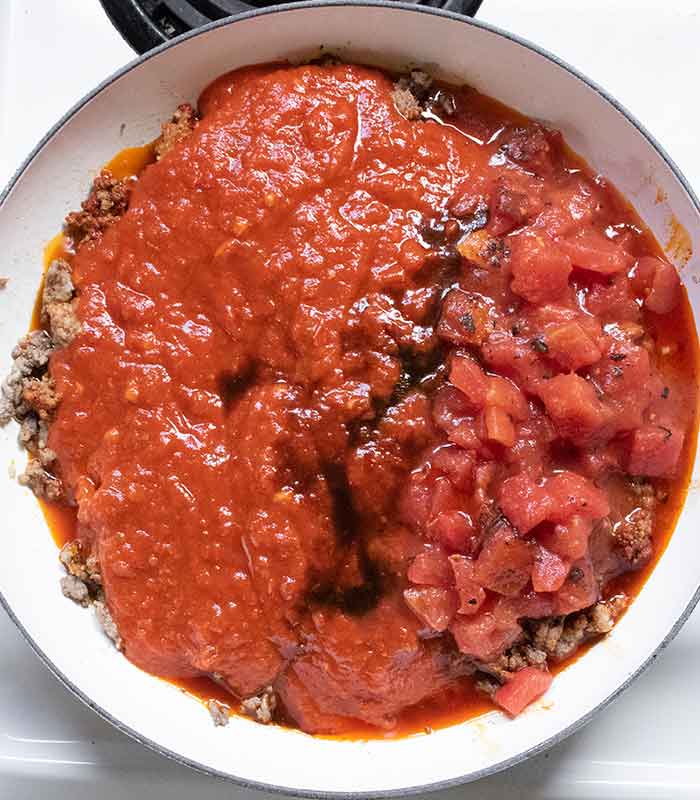 Pasta sauce, diced tomatoes, and Worcestershire sauce go in next.