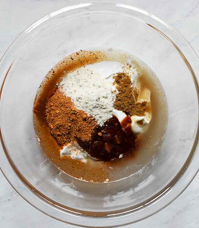 Dressing ingredients in a glass bowl.