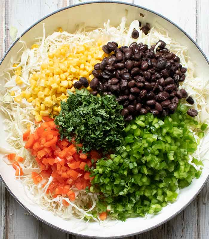 Add the peppers, corn, beans and cilantro to the bowl.