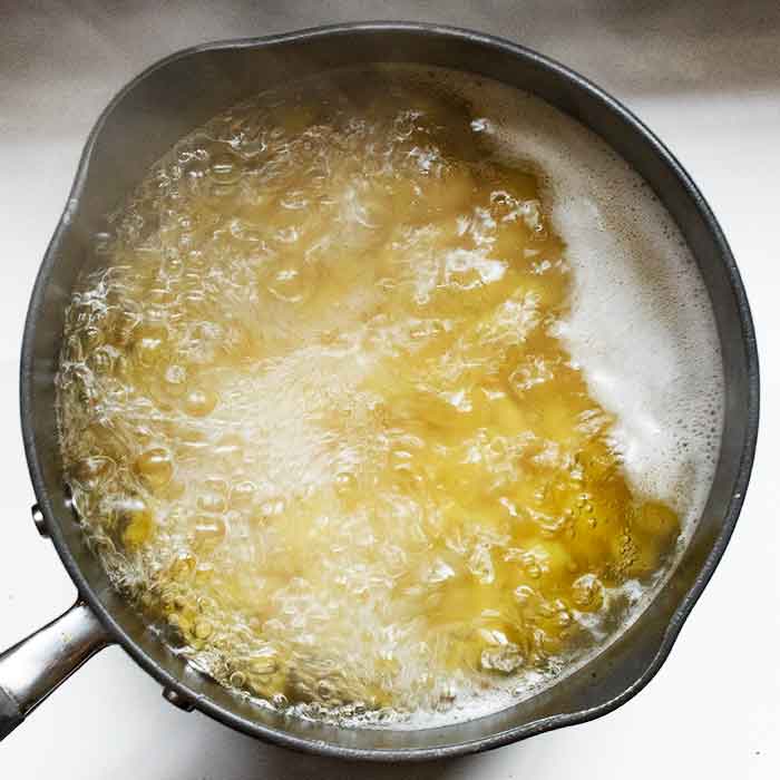Pasta cooking in a pot on the stove.