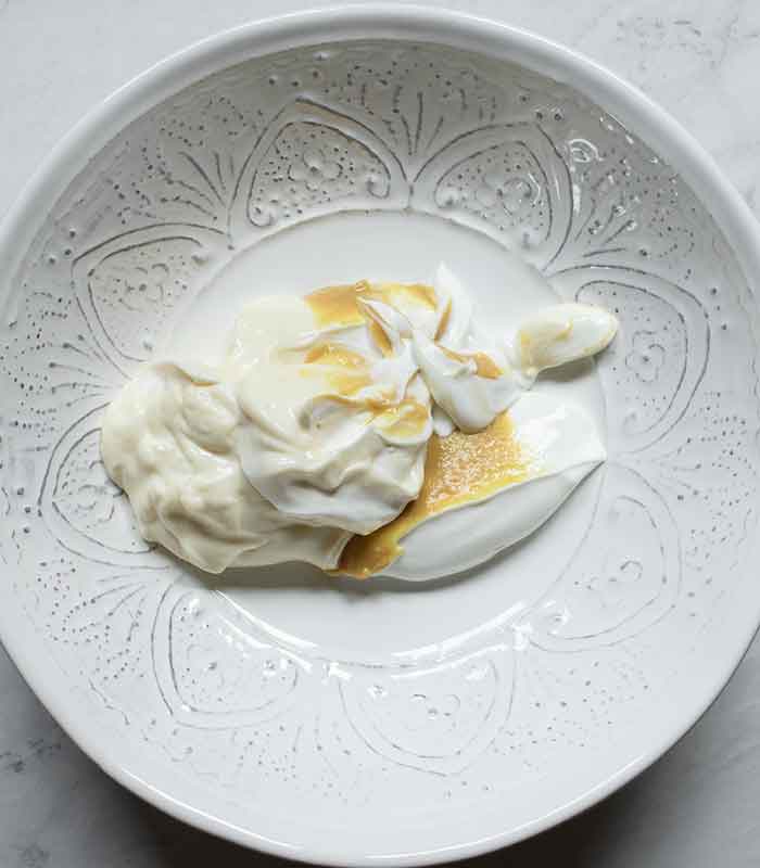 Dressing ingredients in a large white bowl.