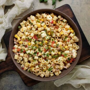 Cowboy Caviar Pasta Salad in a bowl on a serving board.