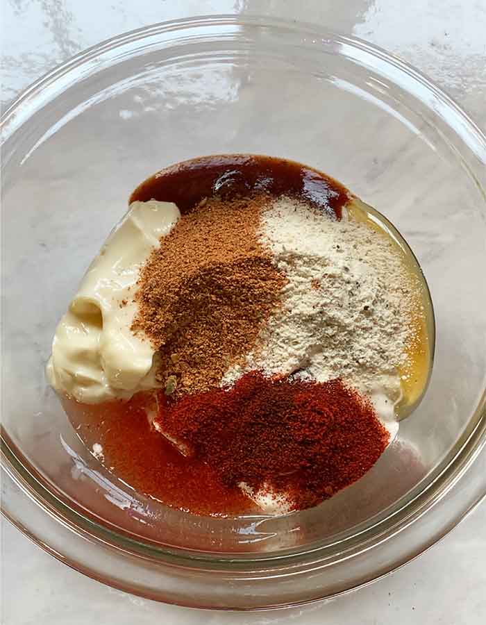 Dressing ingredients in a small glass mixing bowl.