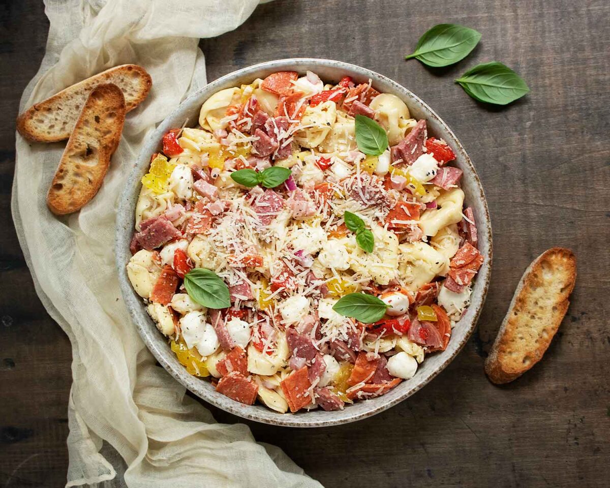Italian Grinder Tortellini Salad with bread slices on the side.