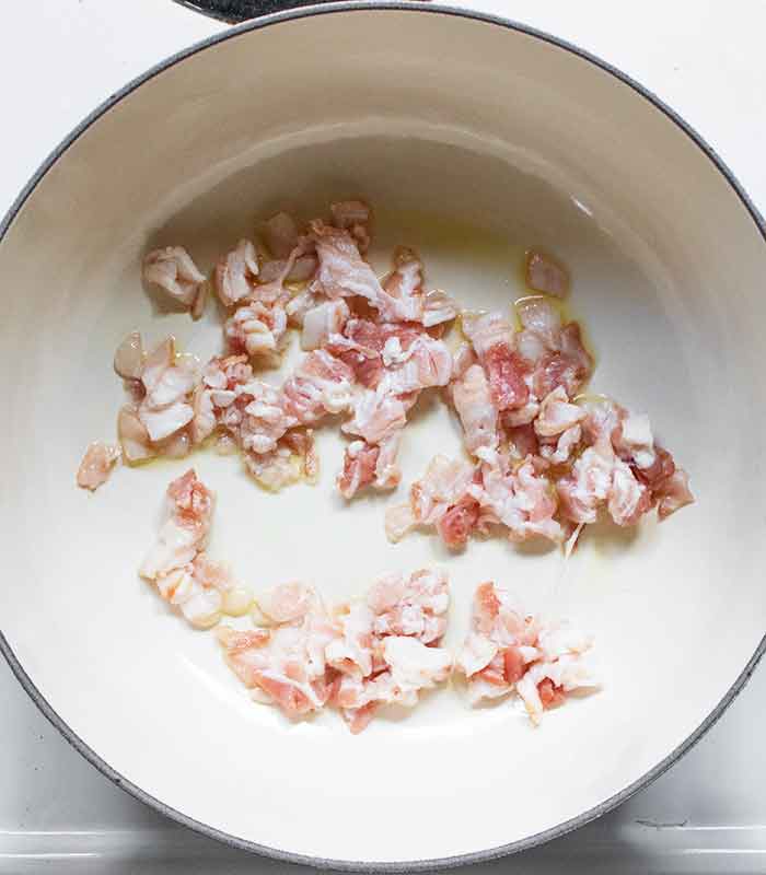Raw bacon cooking in the soup pot.