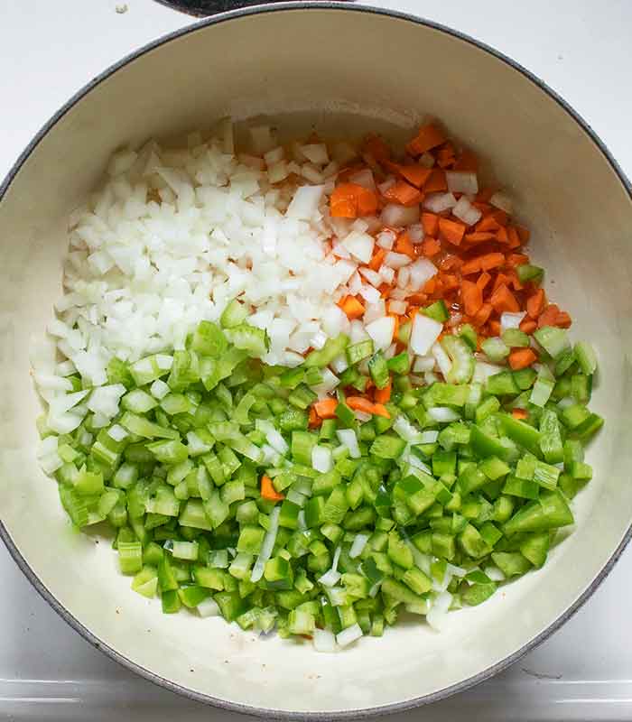 Add the aromatic vegetables to the rendered bacon fat in the soup pot.