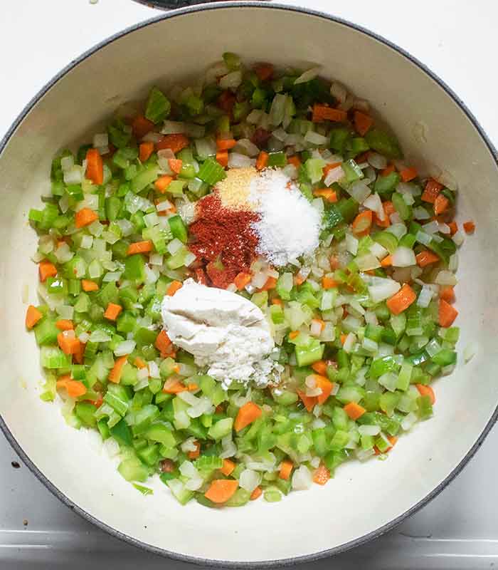 Spices and flour added to the softened vegetables.