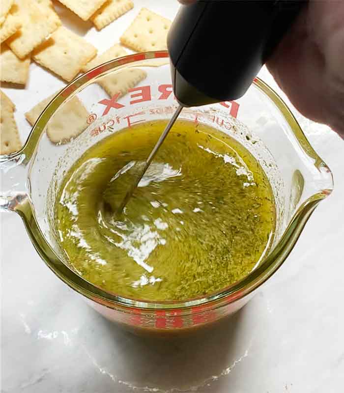 Blending the oil and seasonings with a milk frother.