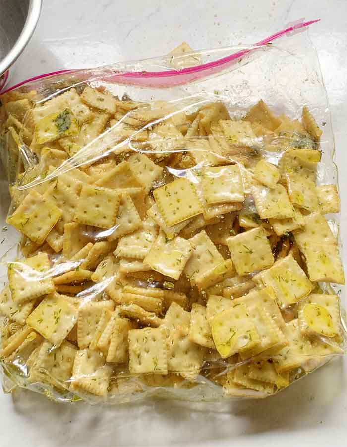 The crackers coated and ready to transfer from the zipper to a baking sheet.