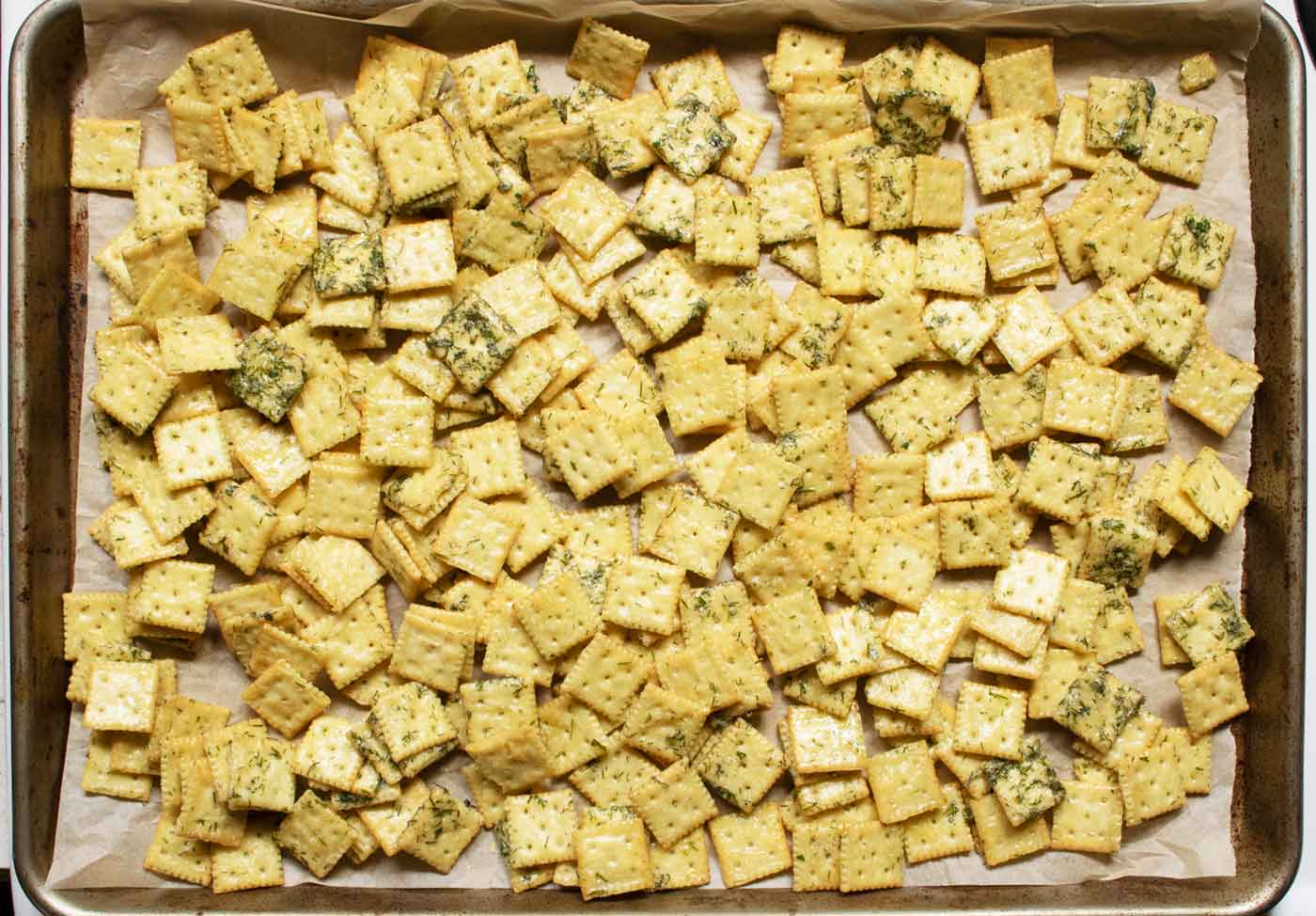 The Dill Pickle Saltines baked and cooling on the baking sheet.
