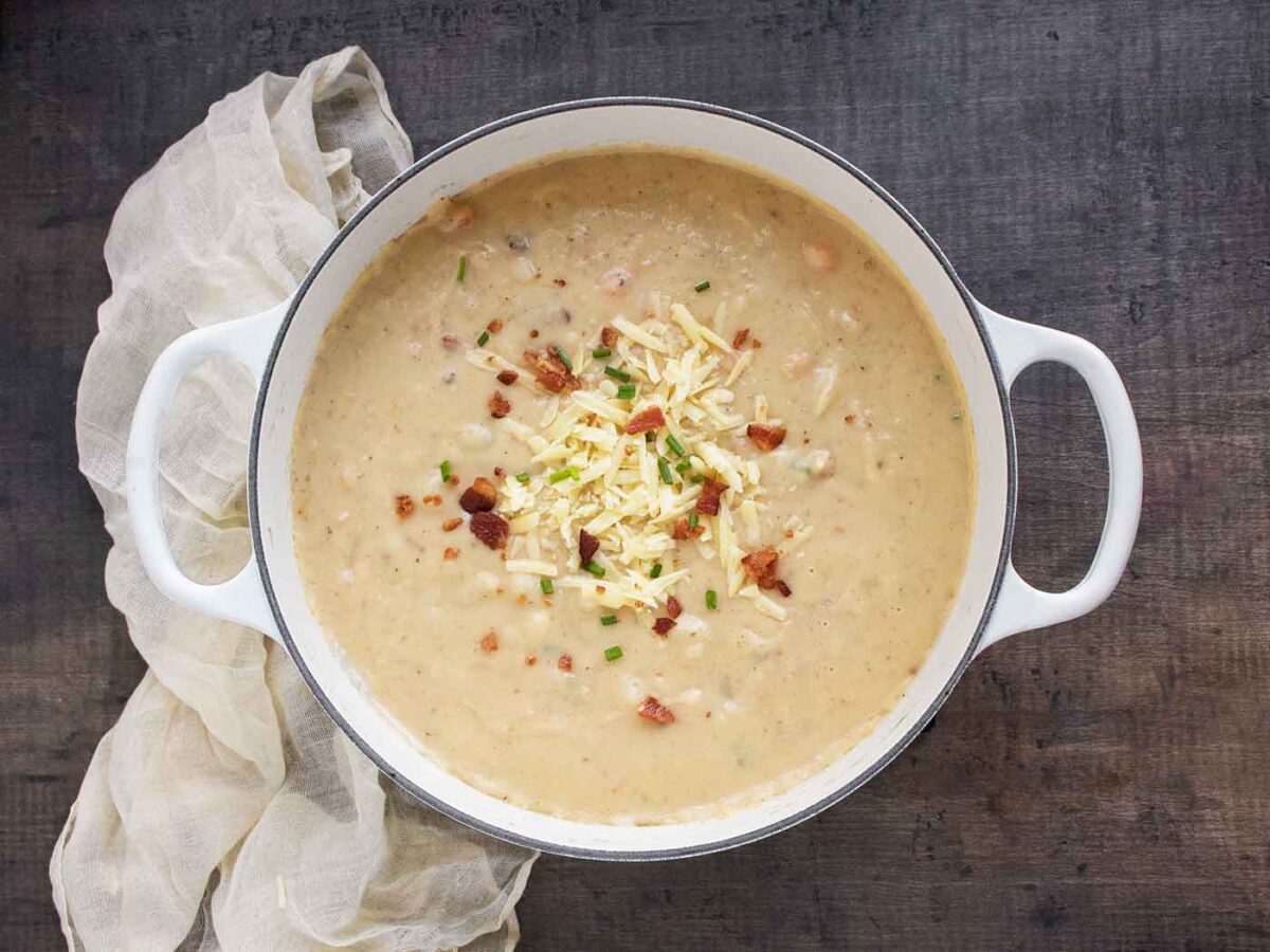 Overhead view of Irish Potato Soup in a white Dutch oven.