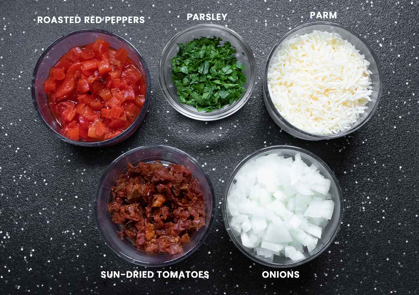 Ingredients that require prep arranged in small glass bowls.