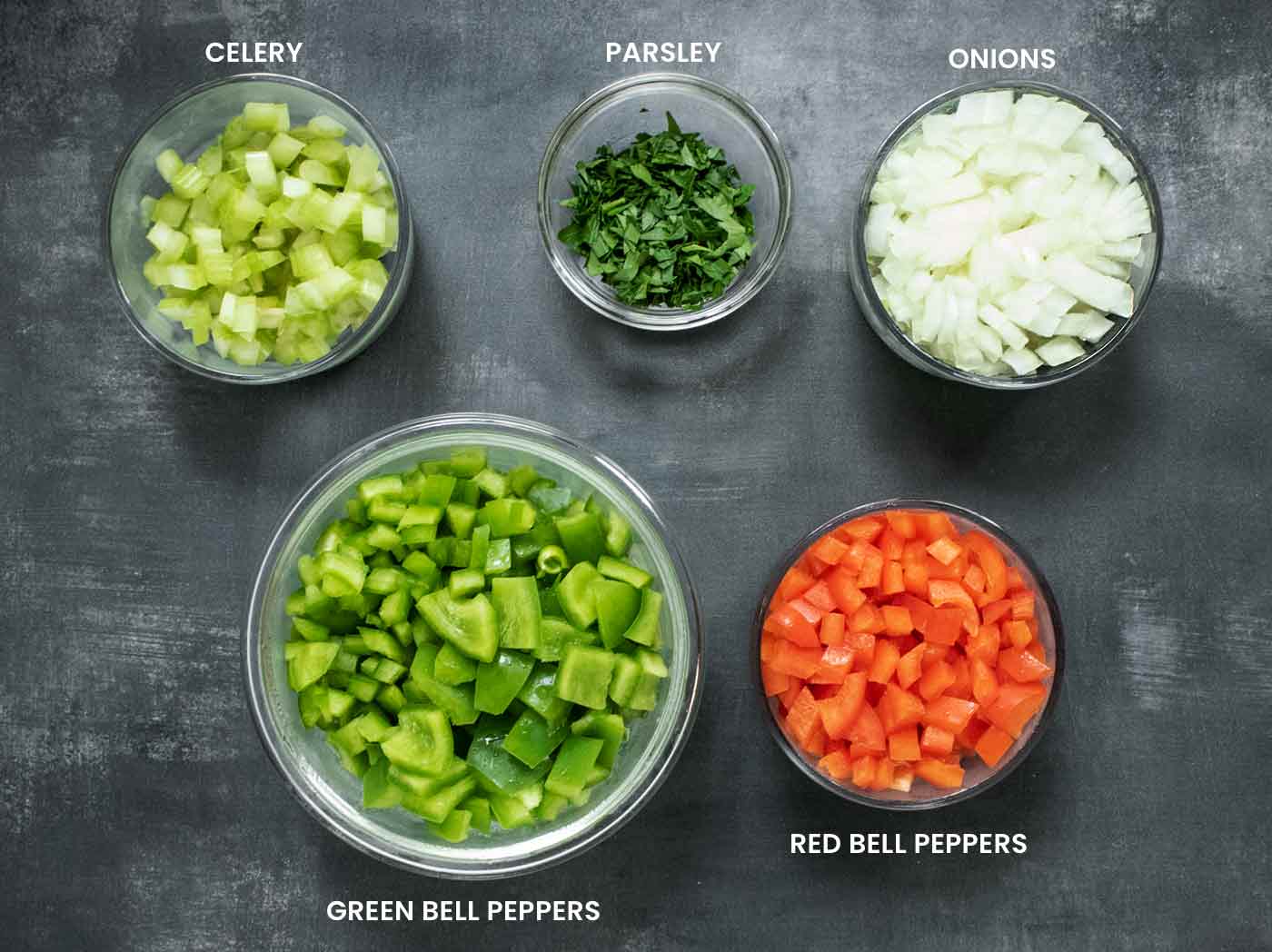 Prepared ingredients in glass bowls arranged on a dark background.