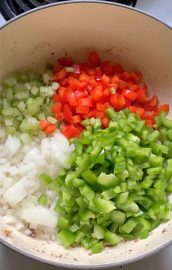 Onions, celery, and bell peppers in the pot.