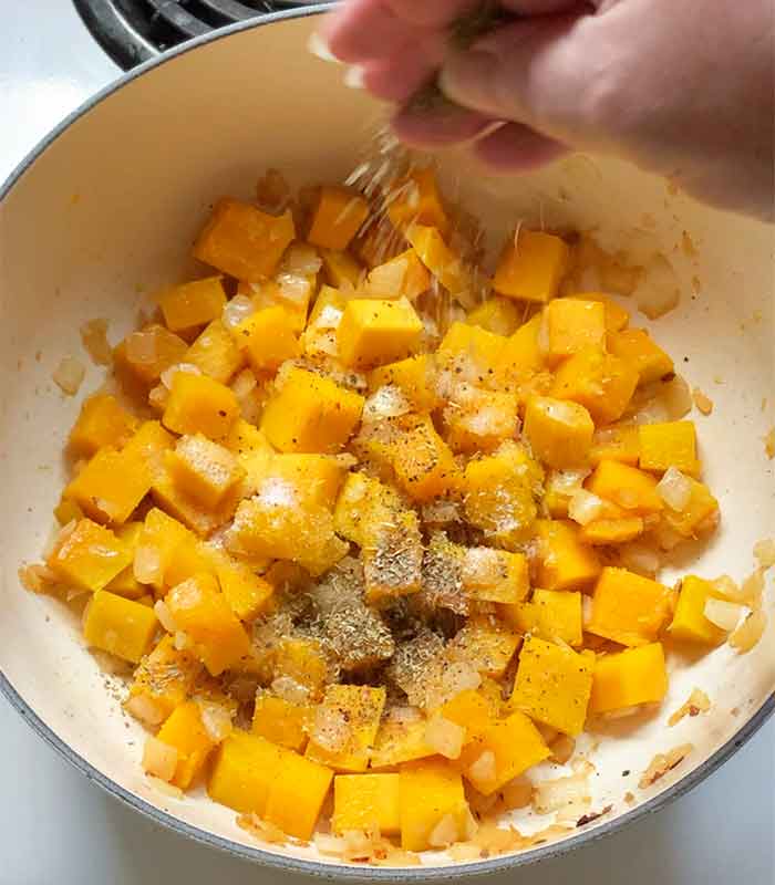 Seasonings get mixed with the softened onions and butternut squash.