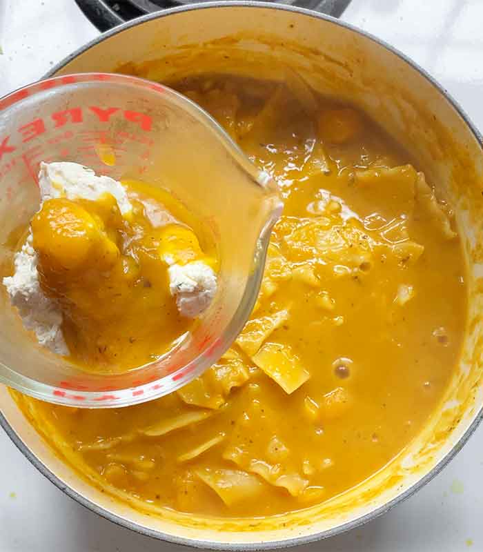 Melting the Boursin with some hot soup - will whisk with cream for a smooth sauce.