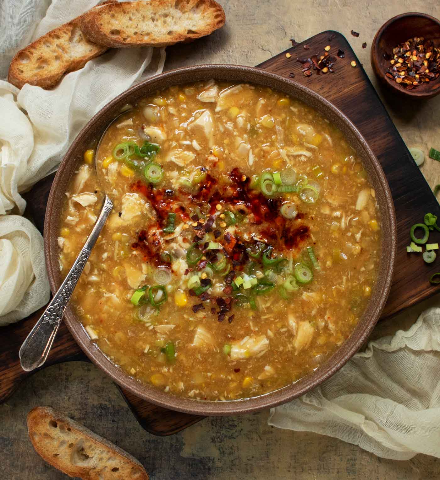 Overhead view of the soup in a bowl with spoon and toppings.