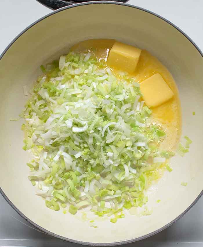 Chopped leeks cooking melted butter.