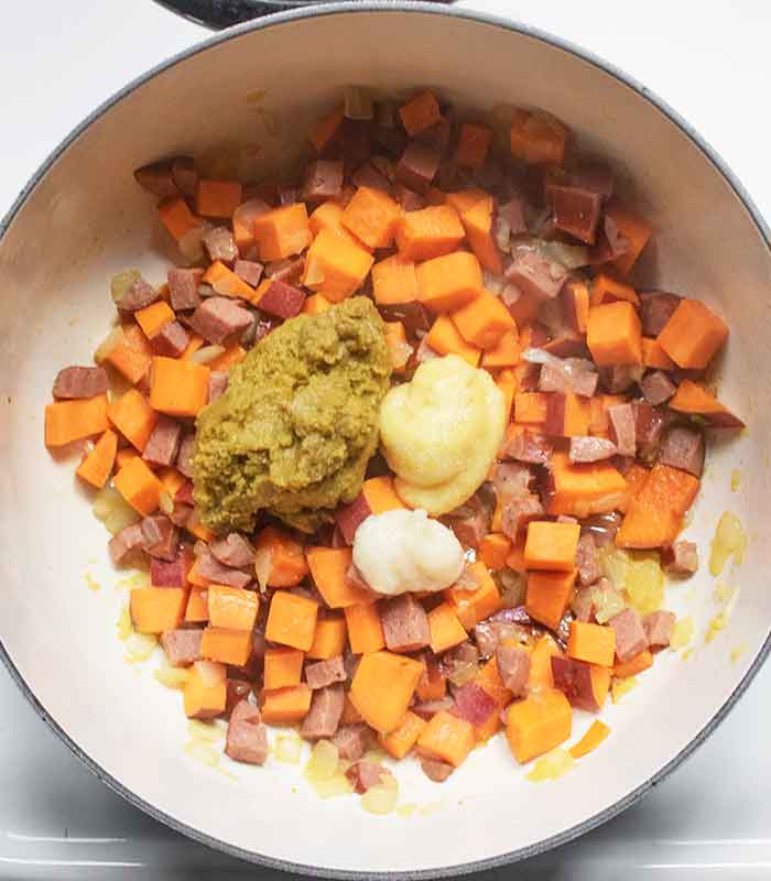 Add the green curry paste, ginger, and garlic to the vegetable mix.