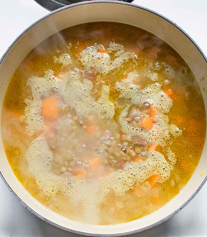 Simmering the soup to cook the lentils.