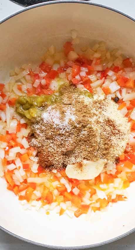 Green chiles, garlic, spices, and hasa marina go in next.