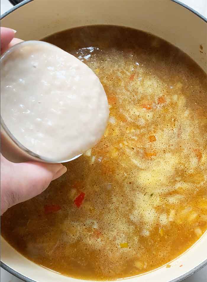 Broth and pureed beans going into the pot.