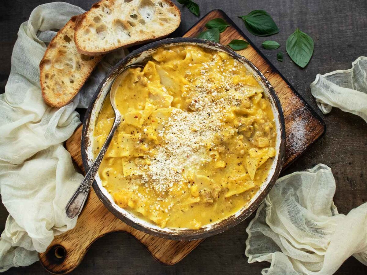 Butternut Squash Lasagna Soup in a rustic bowl with a spoon.