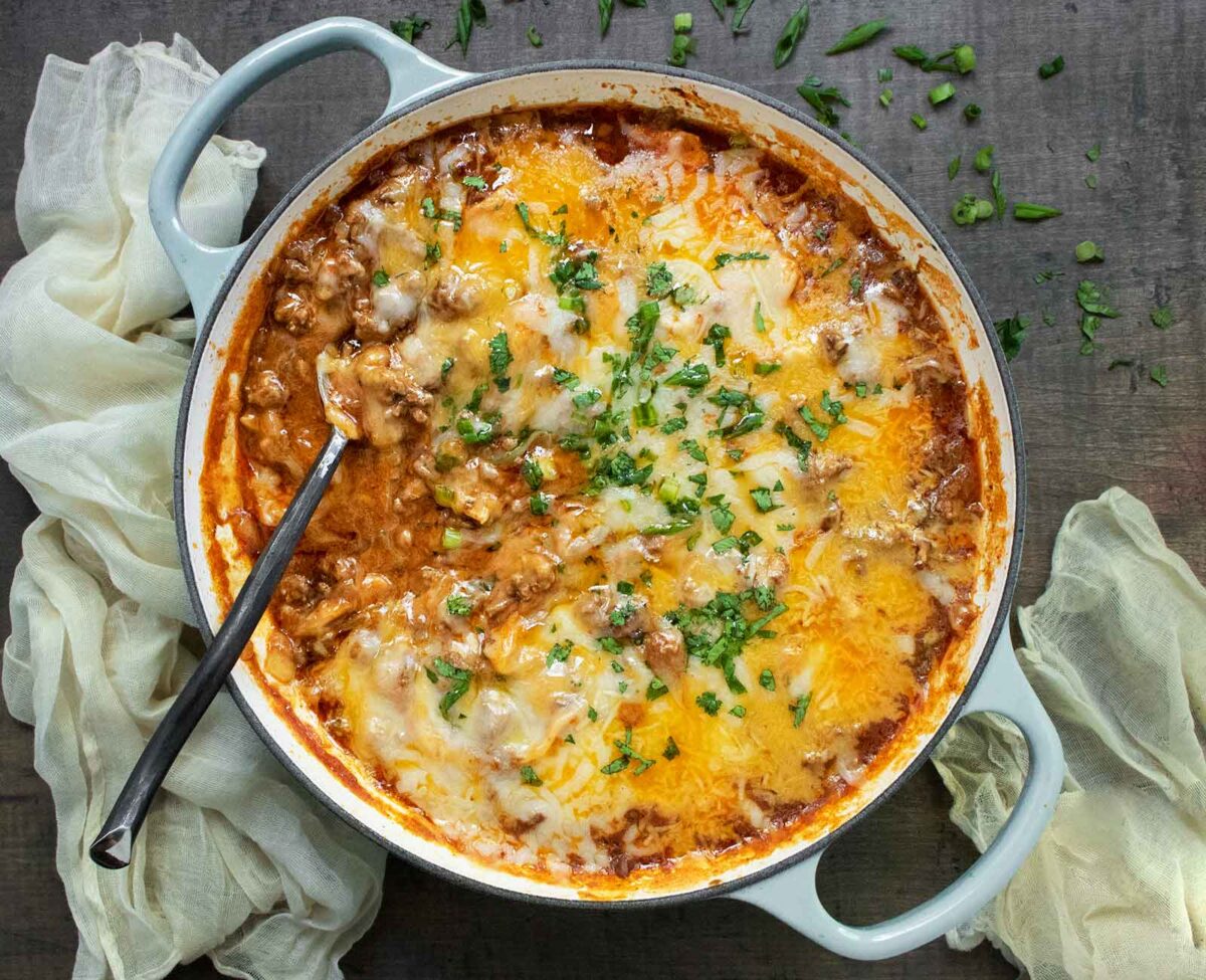 Cheesy Beef Enchilada Skillet with a serving spoon.