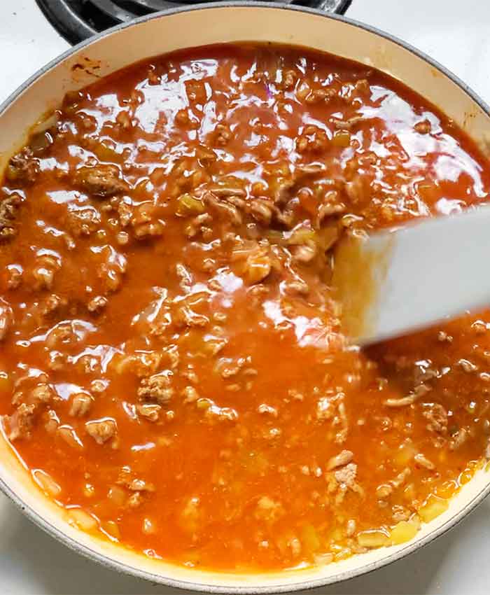 Stirring the enchilada sauce into the beef mixture. With the spurtle.