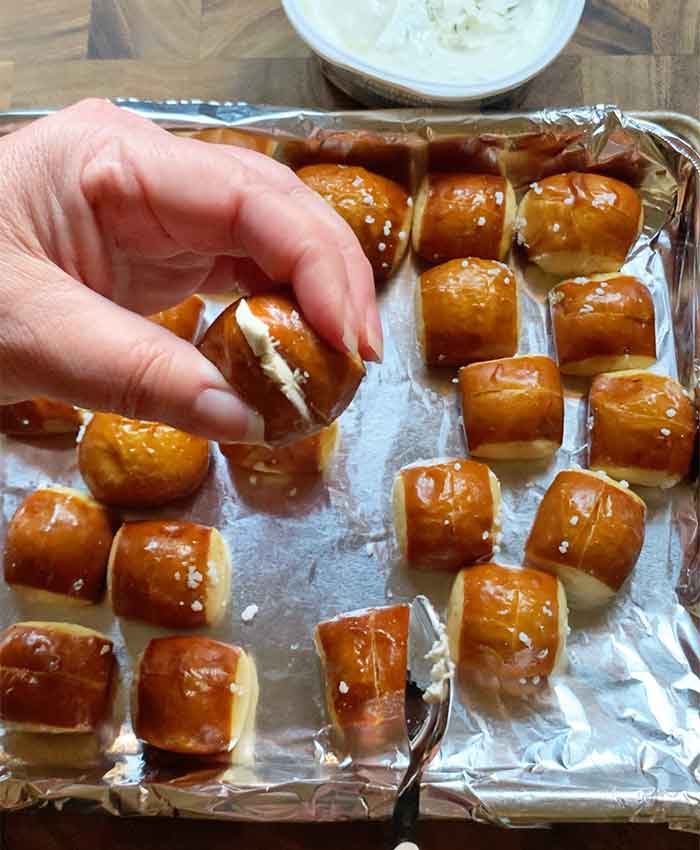 Pressing the sides of the pretzel bite together gently so they're held together by the cream cheese. Kind of like glue, only delish!